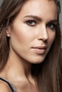 Woman, closeup and face in natural beauty with makeup for skincare, contour or foundation against a grey studio