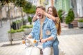 Woman closing her boyfriends eyes while riding a scooter Royalty Free Stock Photo