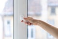 Woman closing pvc window with double glazing Royalty Free Stock Photo