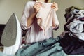 Woman with clothes in her hands. During ironing Royalty Free Stock Photo