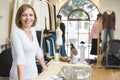 Woman at clothing store smiling Royalty Free Stock Photo