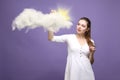 Woman with cloud and sun. Concept on the topic of computer cloud services. Royalty Free Stock Photo