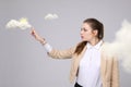 Woman with cloud and sun. Concept on the topic of computer cloud services. Royalty Free Stock Photo