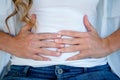 woman clutching her stomach in discomfort