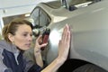Woman coach-builder polishing car