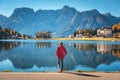 Woman on the coast of Misurina lake at sunrise in autumn Royalty Free Stock Photo