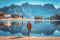 Woman on the coast of Misurina lake at sunrise in autumn Royalty Free Stock Photo