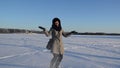 Woman coat gloves throw fluffy friable snow wind fun winter