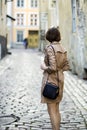 Woman at coat with handbag turned her back Royalty Free Stock Photo