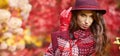 Woman in coat with hat and scarf in autumn park Royalty Free Stock Photo