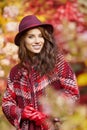 Woman in coat with hat and scarf in autumn park Royalty Free Stock Photo