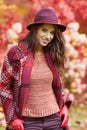 Woman in coat with hat and scarf in autumn park Royalty Free Stock Photo