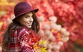 Woman in coat with hat and scarf in autumn park Royalty Free Stock Photo