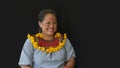 Woman of the Cofan ethnic group smiling in traditional clothing in the Cofan Dureno millennium community located on the edge of