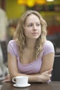 Woman With Coffee Cup Leaning On Table In Mall Royalty Free Stock Photo