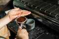 Woman coffee shop worker preparing coffee on professional coffee machine