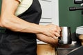 Woman coffee shop worker preparing coffee on professional coffee machine