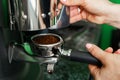 Woman coffee shop worker preparing coffee on professional coffee machine