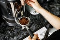 Woman coffee shop worker preparing coffee on professional coffee machine