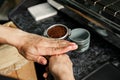 Woman coffee shop worker preparing coffee on professional coffee machine