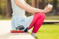 Woman with coffee sitting next to her books and headphones Royalty Free Stock Photo