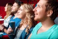 Woman with coke in cinema between viewer Royalty Free Stock Photo