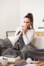 Woman in cold and flu sneezing nose with tissue Royalty Free Stock Photo