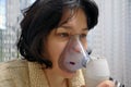 A Woman With Colds Takes A Breath. Woman Holding Inhale Mask.