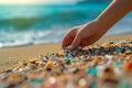 Woman collect micro plastics collects plastic from beach sand. Environment, pollution, plastic waste concept Royalty Free Stock Photo