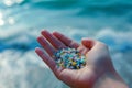 Woman collect micro plastics collects plastic from beach sand. Environment, pollution, plastic waste concept Royalty Free Stock Photo