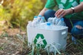 A woman collecting garbage plastic bottles into a recycle bin Royalty Free Stock Photo