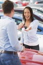 Woman collecting keys to new car