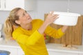 woman collecting leaking water in bucket Royalty Free Stock Photo