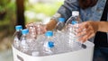 A woman collecting and separating recyclable garbage plastic bottles into a trash bin Royalty Free Stock Photo