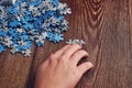 Woman collecting the small pieces of a puzzle - the concept of problem-solving Royalty Free Stock Photo