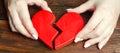 A woman collects a broken heart in his hands. Concept of love and relationships. Family psychotherapist services. Reconciliation.