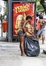 Woman collects garbage at the street in Rio