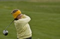 Woman collegiate golfer swinging driver