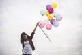 Woman with colorful balloons outside blue sky. Royalty Free Stock Photo