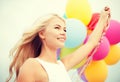 Woman with colorful balloons outside Royalty Free Stock Photo