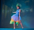 Woman in colorful dress dancing ballet on stage