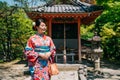 Woman with colorful kimono finished praying Royalty Free Stock Photo