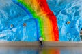 Woman on colorful rainbow art at subway. Underground in Stockholm.