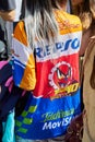 Woman with colorful shirt with Repsol logo before Msgm fashion show, Milan Fashion Week street