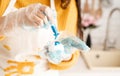 Woman coloring easter eggs blue in the kitchen Royalty Free Stock Photo