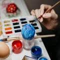 Woman coloring Eggs for Easter celebration on April. Preparing and painting for family celebrate and home decoration. Royalty Free Stock Photo