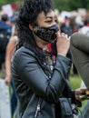 UK, London, 3/6/2020 - A woman of colour wearing a patent leather Black Lives Matter PPE face mask with spikes at a Black Lives Ma Royalty Free Stock Photo