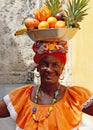 Colombian woman with basket of fruits on her head Royalty Free Stock Photo