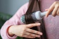 Woman combing her sleek hair. takes care of healthy and clean hair. Beauty salon concept.