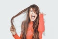 Woman combing her tangled hair.